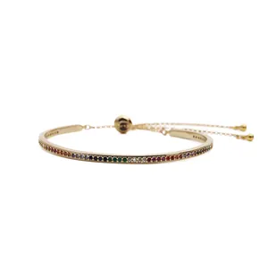 Adjustable gold bracelet featuring a rainbow gradient of micro-pave cubic zirconia stones