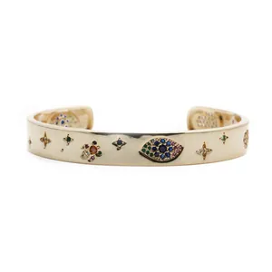 Detail showing the Evil Eye motif and colored cubic zirconia on a gold cuff bracelet