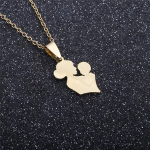 Detailed close-up of golden mother and child silhouette pendant on a delicate chain