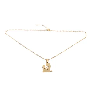 Detail of gold-plated stainless steel necklace with mother and child silhouette pendant