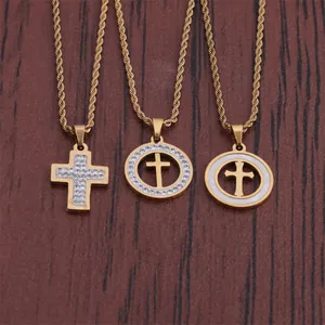 Three gold hip hop cross necklaces with iced out details on a wooden background