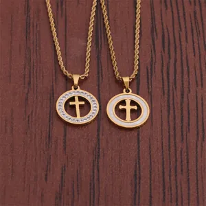 Detail of gold-plated hip hop cross pendants with rhinestones and white shell inlay