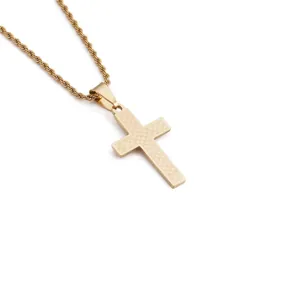 Detailed macro of gold cross pendant with grid texture and matching rope chain