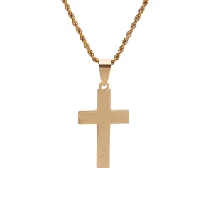 Macro detail of gold cross pendant with grid texture and twisted rope chain necklace