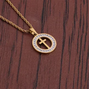 Detail of gold hip hop cross pendant with micro-inlaid stones on a wood background