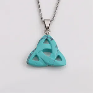 Macro view of Celtic Triquetra pendant with turquoise stone texture on silver chain