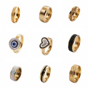 Collage of nine mixed gold plated stainless steel rings with zircon and matte finish