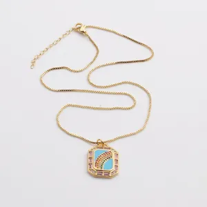 Detail view of the gold-plated box chain necklace with a colorful rainbow zircon pendant