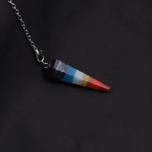 Macro shot of 7 chakra natural stone hexagon prism pendant with silver chain necklace