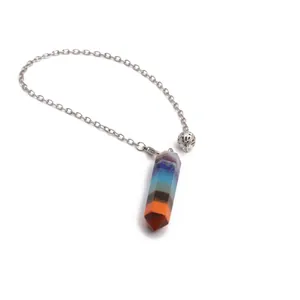 Macro detail of hexagonal prism 7 chakra crystal pendulum with silver chain and bead