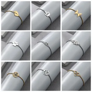 Detail of nine stainless steel bead bracelets with various gold and silver charms