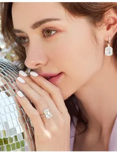 Close-up of luxury emerald cut ring and matching earrings with micro-pave crystals