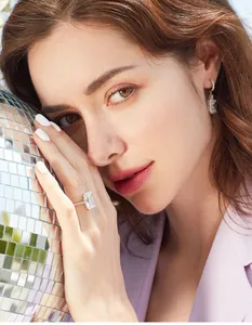 Elegant rectangular princess cut diamond ring and earrings set worn by a model