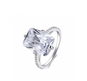 Close-up of luxury emerald cut square sparkling diamond ring with micro-pave band details