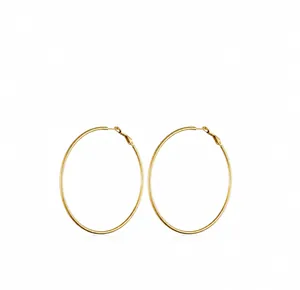 Detailed view of large gold hoop earrings with lever-back closure and sleek metal finish
