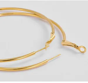 Close-up of golden hoop earring showing the secure click-top closure mechanism
