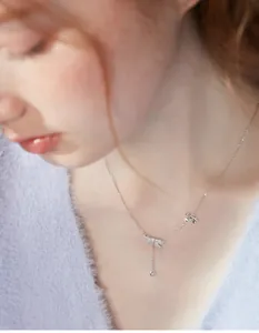 Dettaglio della collana a nappa in argento con fiocchi e cristalli sulla clavicola