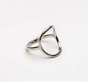 Detail of minimalist geometric hollow silver ring with polished finish and teardrop design