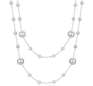 Detail of double-layer silver necklace with gradient beads and high-gloss finish