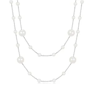 Detail of layered pearl necklace featuring varied white pearls and silver beaded chains