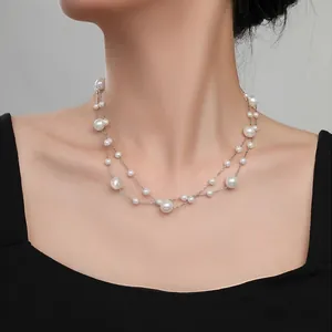 Elegant double-layered white pearl necklace with silver chain on black clothing