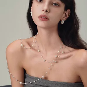 Lange weiße Perlenkette mit Silberkette im Lagenlook und passenden Ohrringen am Modell