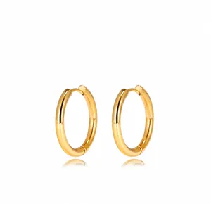 Detailed view of polished gold hoop earrings with mirror finish and secure clasp