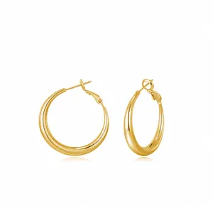 Close-up of chunky gold hoop earrings with polished finish and secure latch back closure
