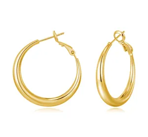 Detailed close-up of polished gold hoop earrings with secure needle clasp on white background