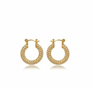 Macro detail of gold hoop earrings with three rows of micro-pave crystal zircons