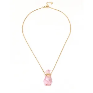 Detailed close-up of a pink gemstone perfume bottle pendant on a 18K gold-plated chain