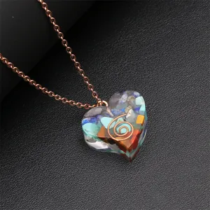 Detailed macro view of heart pendant with colorful natural stones and metal spiral