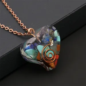 Macro shot of colorful resin heart pendant with natural stones and copper coil detail