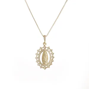 Detail of gold Virgin Mary pendant with micro-pave cubic zirconia and radiant sunray frame