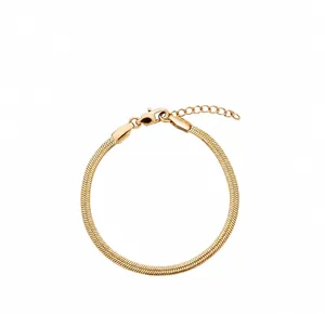 Detailed macro of a flat gold snake chain bracelet with secure lobster clasp design