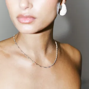 Elegant curved water wave twist necklace with silver finish for a minimalist chic look
