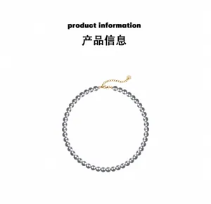 Detail of grey pearl necklace with gold-plated lobster clasp and adjustable extender chain