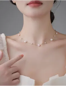 Close-up of elegant French vintage pearl necklace with delicate gold chain on neck
