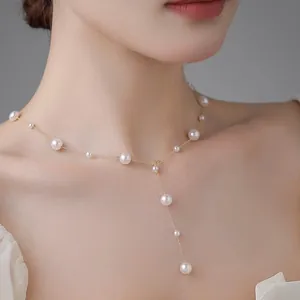 French vintage pearl necklace with elegant Y-shape drop design on female model neck