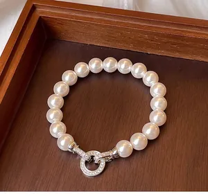 Detail of round pearl bracelet with a sparkling crystal-encrusted silver ring clasp