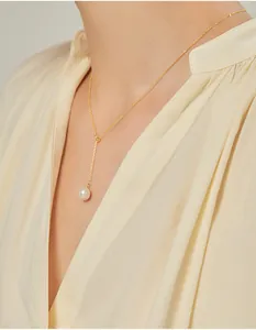 Detail view of a French vintage gold Y-necklace featuring a single lustrous pearl pendant