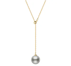 Close-up of gold Y-shaped necklace featuring a lustrous round grey pearl pendant