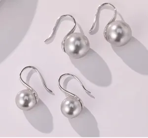 Macro shot of S925 sterling silver drop earrings with metallic gray round pearls