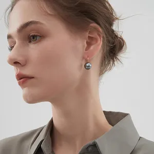 French vintage dark grey round pearl drop earrings with golden clasps on model