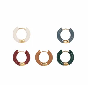 Detail view of colorful enamel hoop earrings in cream, blue, red, camel, and green