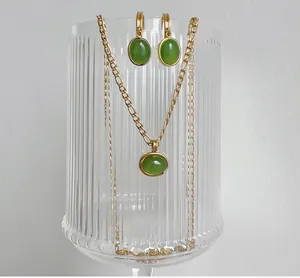 Detail of vintage gold chain necklace and matching green aventurine stone earrings