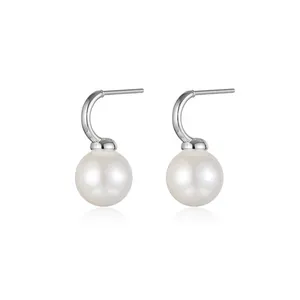 French vintage C-shape silver earrings with round white pearls on white background