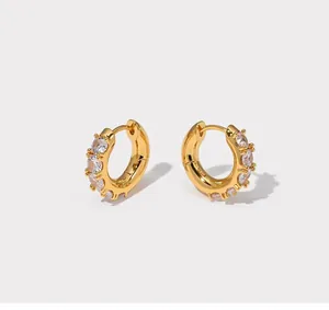 Detailed view of gold-plated hoop earrings featuring claw-set cubic zirconia crystals