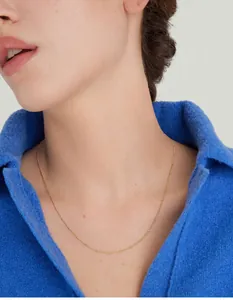 Close-up of 18K gold plated satellite chain necklace worn on neck with tiny beads