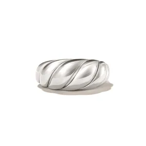 Polished silver croissant dome ring with minimalist spiral texture on white background